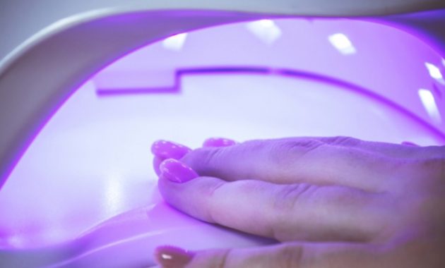 UV lamp gel polish manicure process in a beauty salon
